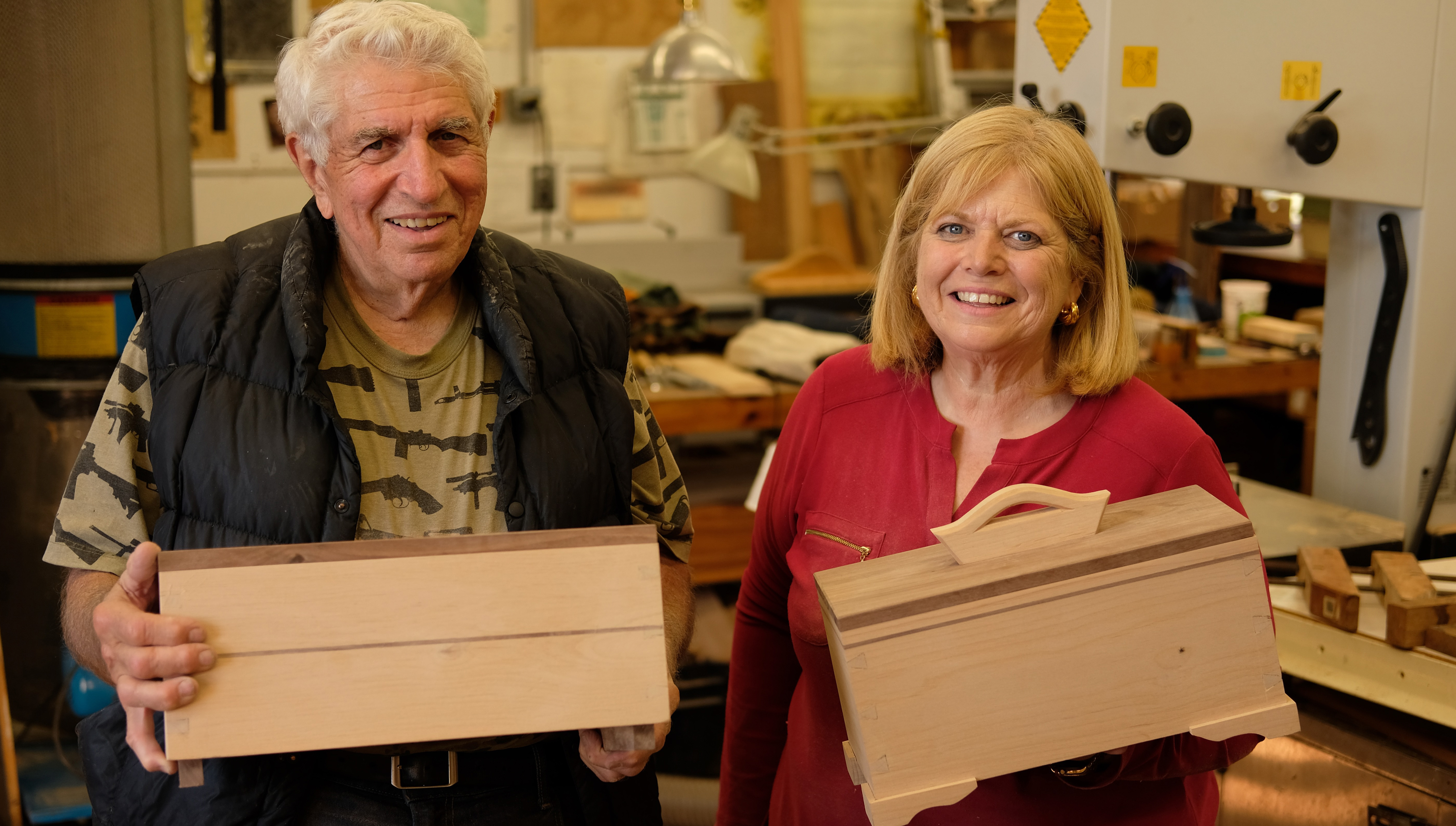 Students holding handcrafted dovetail keepsake boxes at Calvo Wood Carving School