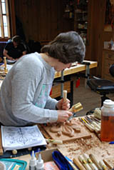 Student learning how to carve with a mallet student carving with mallet