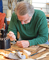 Student using hand technique in carving wood carving classes to show how to hold a wood carving tool